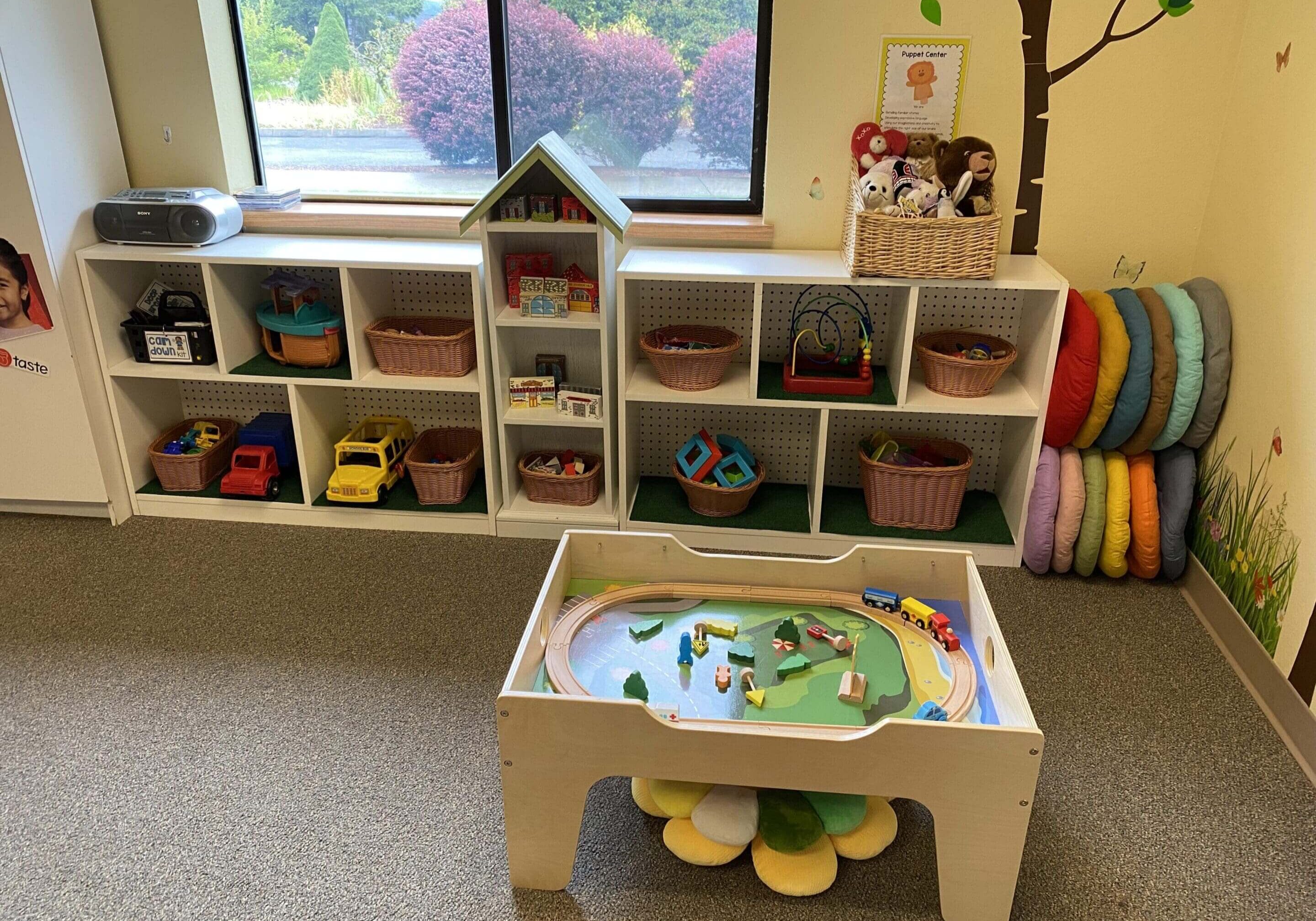 Activity train table with rainbow floor cushions
