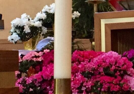 Tall candle in a church setting.