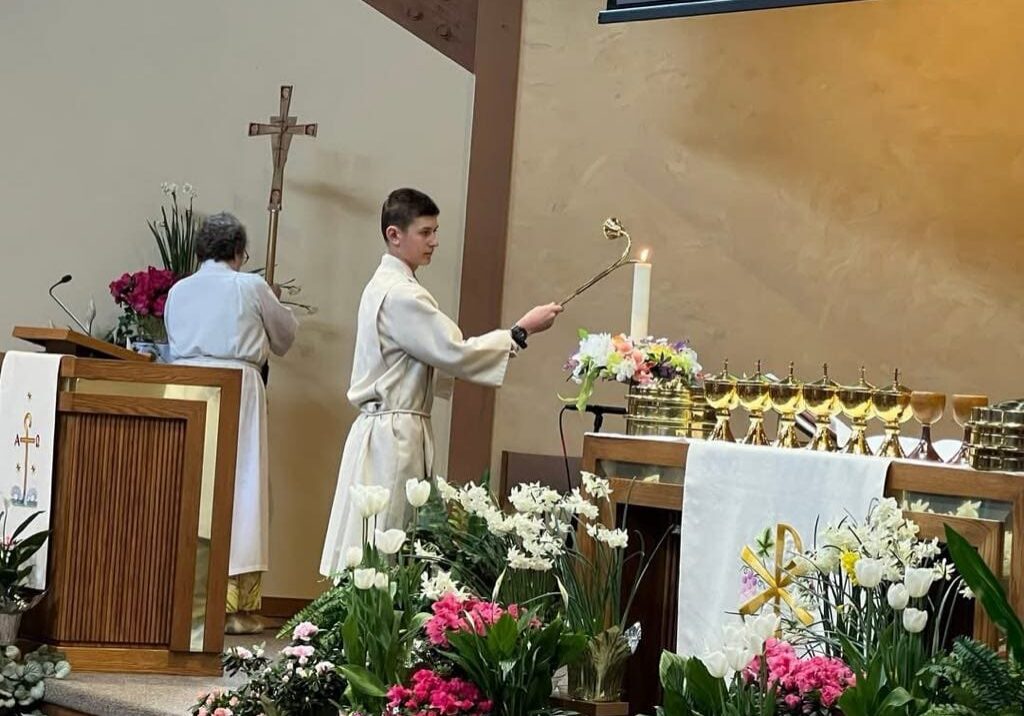 Altar servers lighting candles during service.