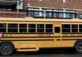 Yellow school bus parked on city street