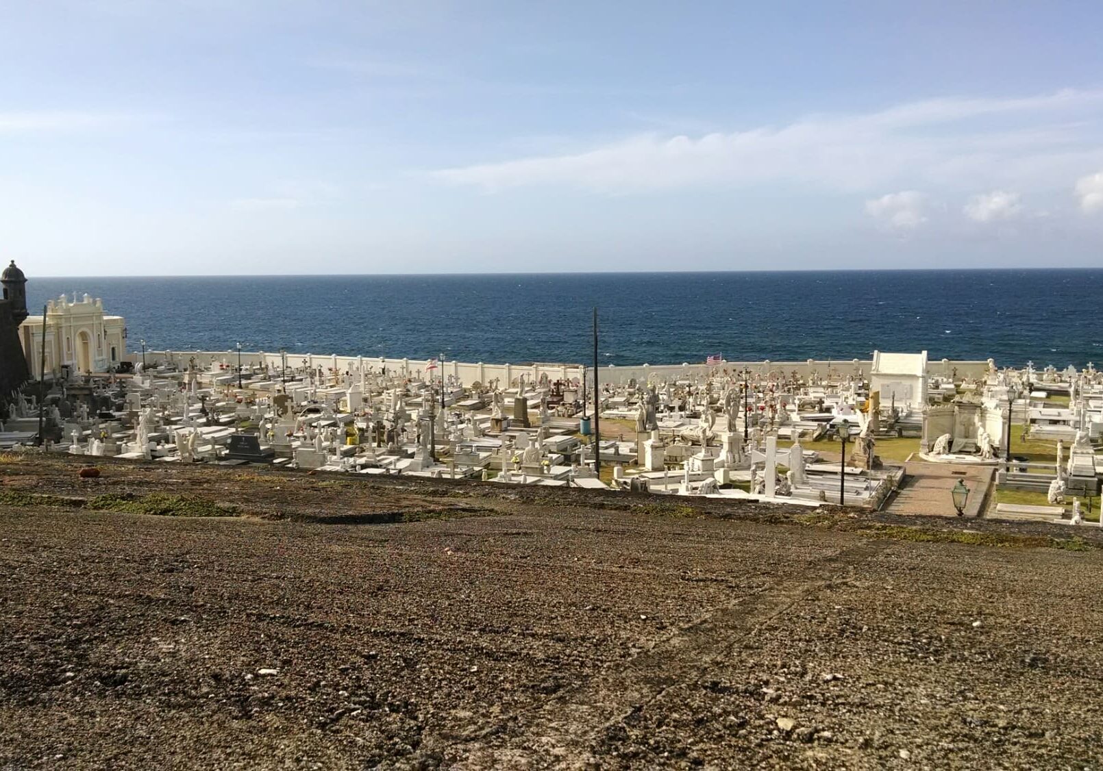 Coastal cemetery overlooking calm blue ocean