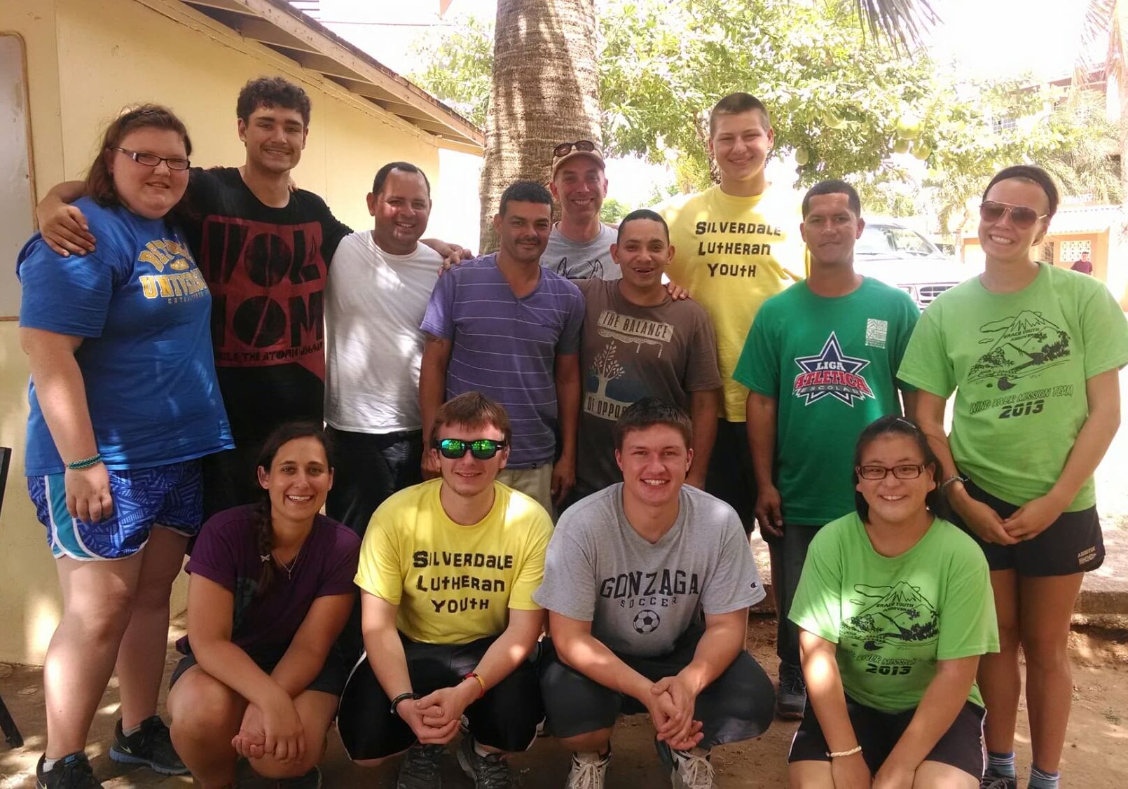 Group of smiling people posing outdoors