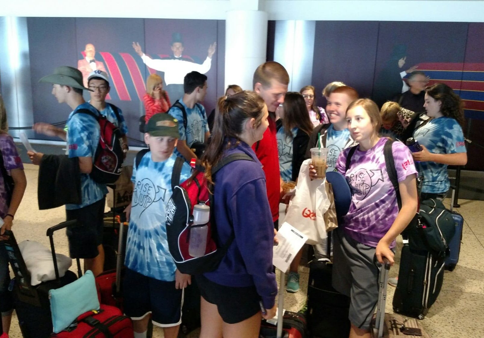 Group of teens with backpacks and suitcases
